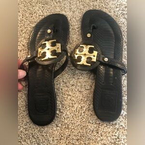 Tory Burch Miller black and gold flat leather sandles with gold metal medallion